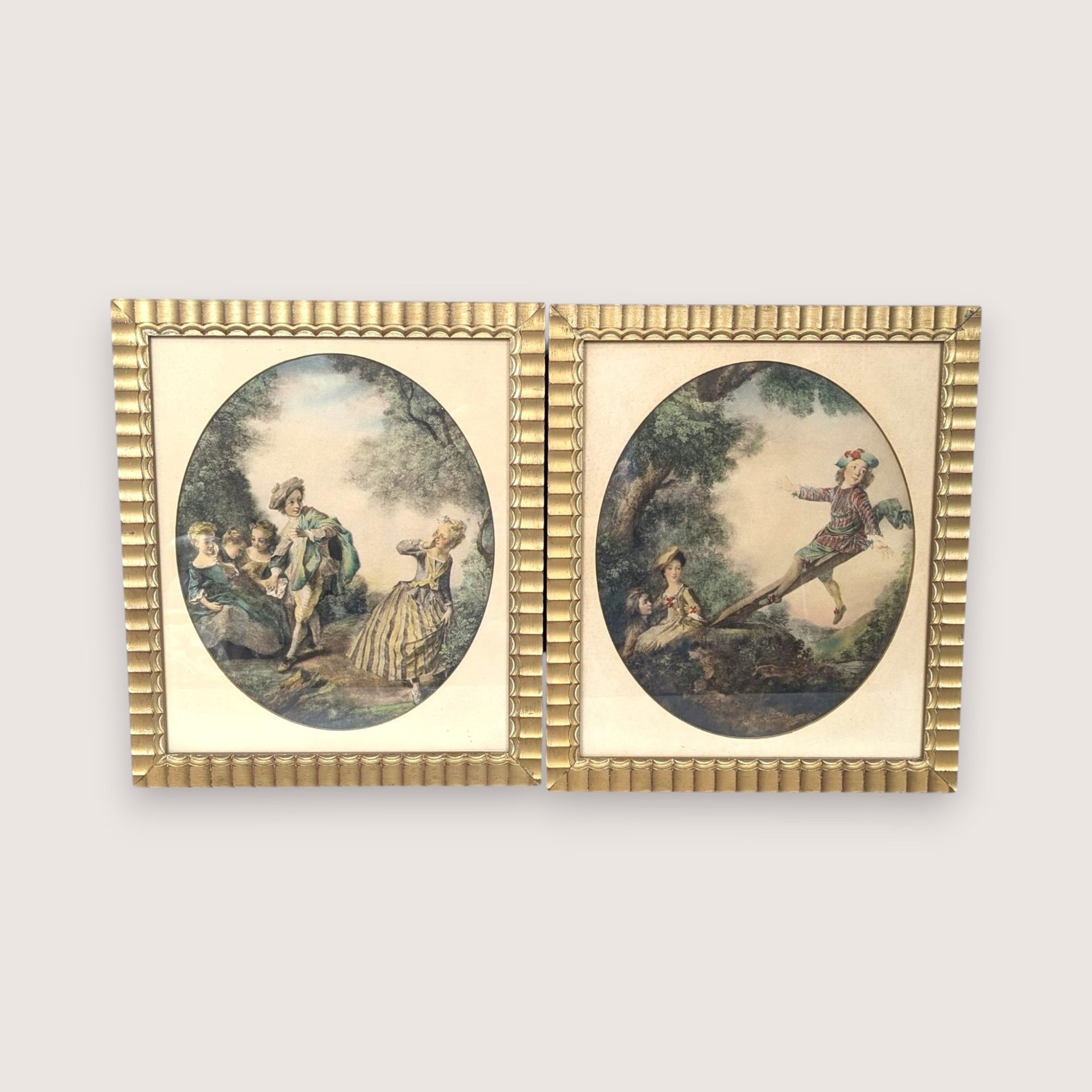 Pair of vintage 1940s Nicolas Lancret framed art prints featuring The Seesaw and Dropping Hankie in gold fluted frames.