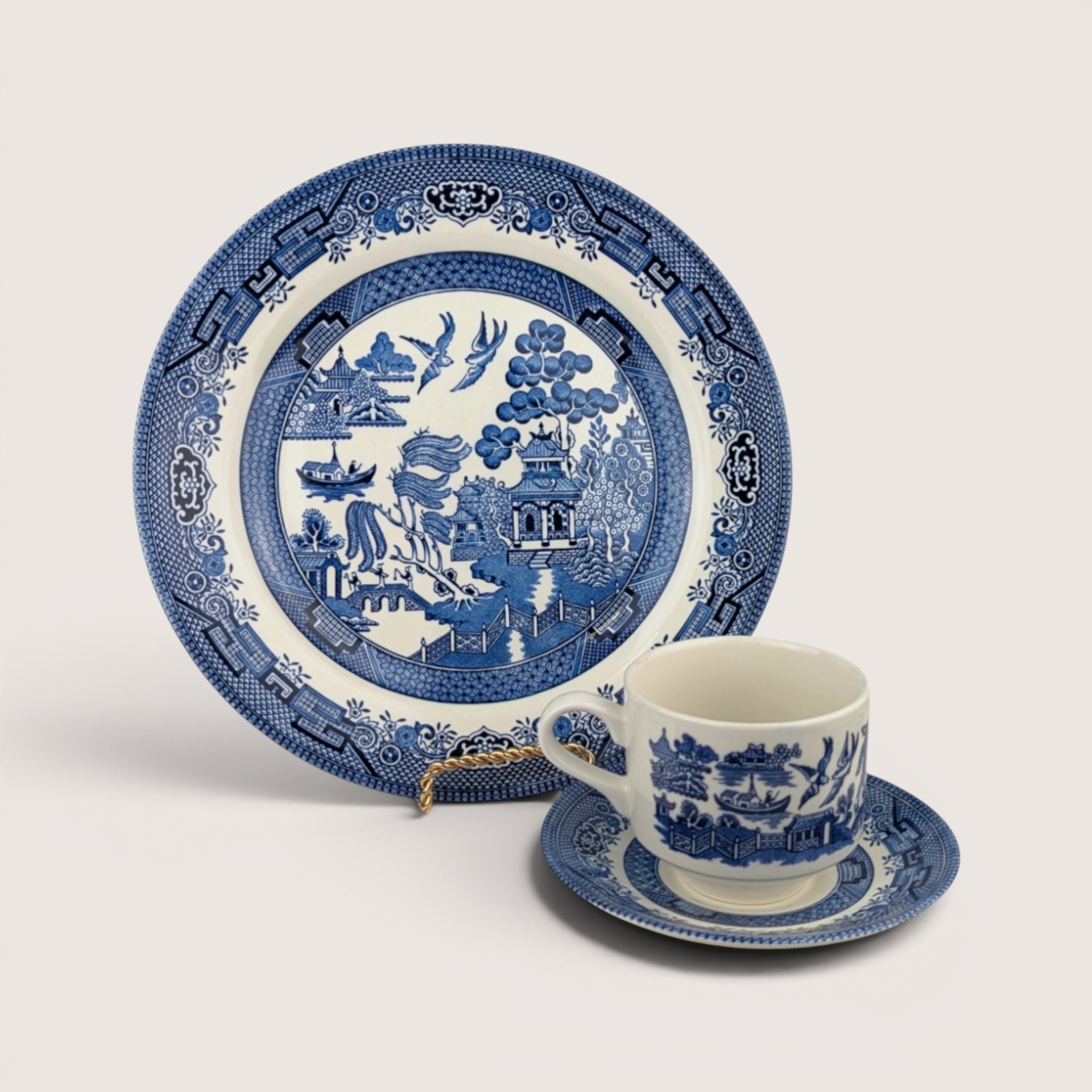 Vintage Churchill Blue Willow 3-piece ceramic set featuring a large dinner plate, tea cup, and saucer in blue and white transferware.