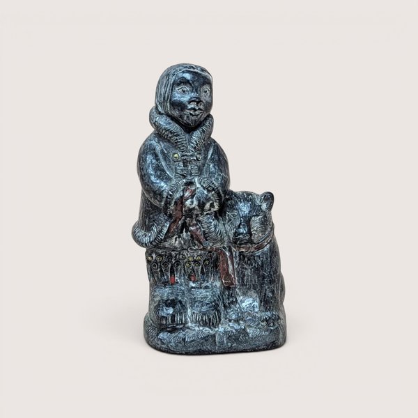 Vintage Wolf Original dark grey molded faux soapstone figurine of an Eskimo standing next to a dog.