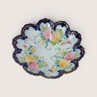 Vintage hand-painted porcelain bowl featuring a scalloped cobalt blue and gold gilt rim with delicate floral details.