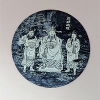 Round black and white veined marble plaque with a detailed white line engraving of three figures in traditional Chinese robes representing the City God (Cheng Huang). 8 inches in diameter.