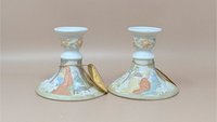 Pair of matte bisque Lefton candle holders featuring a 3D relief of the Nativity scene. Soft pastel colors of peach, blue, and sage green on a white ground. Includes original gold string hang tags.