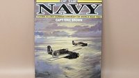 Hardcover book titled "Wings of the Navy" by Capt. Eric Brown. Dust jacket features a painting of two Allied fighter planes flying over a sunset-lit sea. 1987 edition.