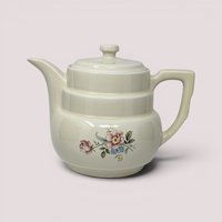 Vintage cream ceramic Hall Rambling Rose coffee pot with lid featuring a colorful floral pattern.