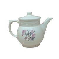 Vintage cream ceramic Drip-O-Lator coffee pot and lid. Features a central floral spray of pink tulips and white daisies. Sculptural scroll-top handle and tiered "stepping" on the neck. 7.25 inches tall.
