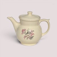 Vintage cream ceramic Drip-O-Lator coffee pot with lid featuring a pink floral decal design.