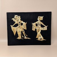 Vintage Asian folk art picture made of shimmering golden wheat straw. Features a man and woman in traditional ceremonial dress on a black fabric background. 11.5 by 15 inches.
