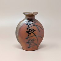 Vintage Brad Lee Henry studio pottery vase. Features a bulbous body in earthy red-brown with a metallic tenmoku drip glaze and black calligraphic slip-painted accents. 5 inches tall.