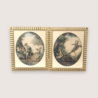 Set of two 1940s framed art prints by Nicolas Lancret titled "The Seesaw" and "Dropping the Handkerchief." Features pastoral Rococo scenes in ornate scalloped gold frames. 14.25 x 12.25 inches.