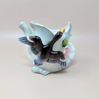 A vintage white ceramic watering can vase from Thames Japan. Features a hand-painted duck in flight across the front with pink floral accents and gold trim along the rim and spout. 4.25 inches tall.