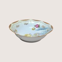 Scalloped octagonal porcelain bowl. Pale blue ombre interior with large pink and yellow roses. Wide rim features heavy gold gilt with a delicate beaded relief texture.