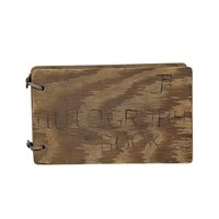 A small, rectangular autograph book with a natural wood grain cover. The words "Autograph Book" are hand-carved into the wood. Two metal rings bind the pages on the left. Rustic, weathered texture with a warm honey-oak finish.