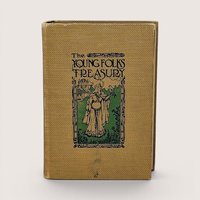 Antique book with a golden-yellow textured cloth cover. Features an Art Nouveau illustration of a woman with a hawk and a castle. Titled "The Young Folks Treasury" in stylized black font. Aged, tactile fabric finish.