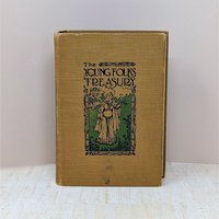 Antique book with a golden-yellow textured cloth cover. Features an Art Nouveau illustration of a woman with a hawk and a castle. Titled "The Young Folks Treasury" in stylized black font. Aged, tactile fabric finish.