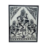 A vertical framed art piece on textured rice paper featuring three Apsara dancers in traditional Cambodian headdresses and poses. Bold black ink on a cream-white background. Framed in a minimalist black wood frame.