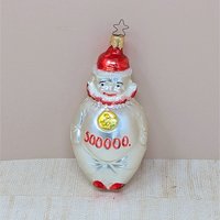 A vertical 5.5-inch blown glass clown ornament with a silvered body. The clown wears a red hat and ruff, with a gold medallion on its chest and "500,000" painted in red across the belly. Topped with a signature star-shaped metal cap.