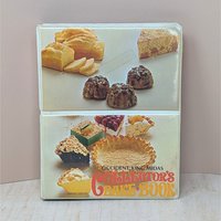A vertical cookbook titled "Occident King Midas Collector's Bake Book." The cover features two panels of 1970s food photography showing pies, cakes, and breads. Orange and yellow "bubble" style typography.
