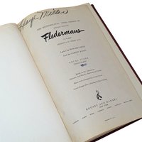 A vintage musical score book titled Fledermaus by Johann Strauss. The title page features elegant black typography and a handwritten signature at the top. The paper shows a warm, aged patina consistent with its mid-century origin.
