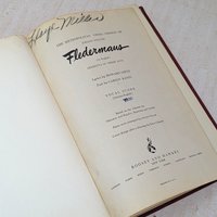 A vintage musical score book titled Fledermaus by Johann Strauss. The title page features elegant black typography and a handwritten signature at the top. The paper shows a warm, aged patina consistent with its mid-century origin.