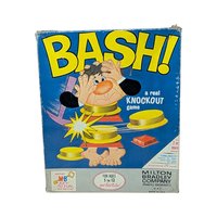 The original 1965 box for the Milton Bradley game "BASH!" featuring a bright blue background and a cartoon man being "bashed" apart. The box shows vintage shelf wear but remains structurally sound with vibrant yellow lettering.