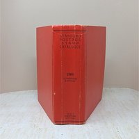 A thick, red hardcover book with a textured spine. The text reads Standard Postage Stamp Catalogue 1968 Combined Edition in black ink. The cover shows gentle edge wear and a slight lean from its substantial page count.