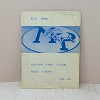 A vintage 1970-1971 "Buzz Book" directory for Mounds Park Junior High, featuring a blue "MP" logo with a galloping mustang on a textured cream cover.