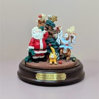 A vintage House of Lloyd musical figurine titled Wreck the Halls. It features Santa Claus looking on in dismay as a reindeer in a tutu and a mischievous cat tangle with a Christmas tree. The scene is set on a dark wood-finish circular base.