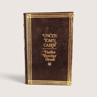 Vintage 1976 hardcover edition of Uncle Tom's Cabin by Harriet Beecher Stowe with faux-leather and gold stamped cover.