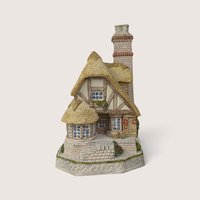 Signed 1991 David Winter miniature cottage sculpture of Audrey's Tea Room with thatched roof.