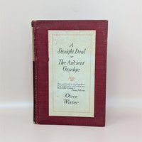 A burgundy cloth-bound hardcover book with a cream-colored title label featuring black typography and a small floral accent against a neutral background.