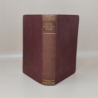 A burgundy cloth-bound hardcover book standing upright, featuring gilded typography on the spine for Robert Browning's Poems against a neutral background.