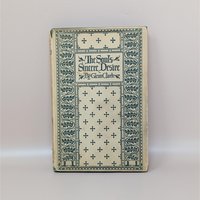 A vintage hardcover book with a cream and teal green patterned cover featuring crosses and floral borders, titled The Soul's Sincere Desire by Glenn Clark.