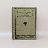 A 1905 hardcover copy of Wilhelm Tell by Schiller, featuring an olive green cloth cover with black ornamental borders and a central heraldic eagle crest.