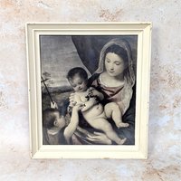 A rare vintage 1950s framed print of Titian's Madonna and Child on a tan textured background. The classic Renaissance lithograph is housed behind glass in a heavy, distressed ivory painted wood frame showing natural age scuffs.