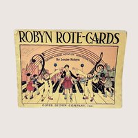 A vintage 1935 softcover music book titled Robyn Rote-Cards featuring a colorful illustration of children and clowns on a piano keyboard