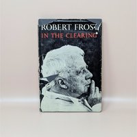 A vintage hardcover edition of In the Clearing by Robert Frost featuring a black and white portrait of the poet on a worn dust jacket