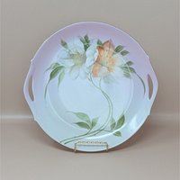 A vintage large porcelain plate from Z.S. & C. Bavaria featuring hand-painted white and orange lilies with a soft pink gradient rim and gold accents.