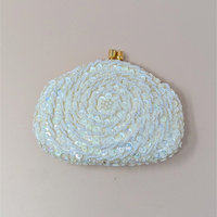 A vintage cream-colored coin purse in file C2040 3.jpg covered in intricate swirls of iridescent sequins and small white beads with a gold kiss-lock closure