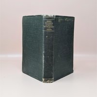 An antique forest green hardcover book titled Eight Hundred Leagues on the Amazon by Jules Verne with gold lettering on a worn spine