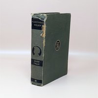 Am anitque 1922 hardcover of Pudd'nhead Wilson by Mark Twain with a green cloth cover and a damaged spine showing the binding underneath