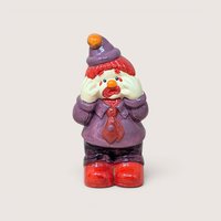 A ceramic sad clown figurine wearing a purple suit and hat with its hands on its face, on a beige background.