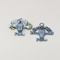 A pair of 1993 pewter MTV Headbangers Ball accessories including a lapel pin with two gold butterfly clutches and a pendant with a top loop