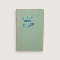 Light green cloth vintage hardcover edition of The Enduring Hills by Janice Holt Giles with blue mountain line graphic.