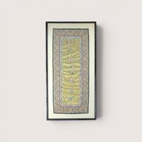 Framed vertical Chinese silk embroidery panel with intricate needlework figurines and a patterned border on a neutral wall