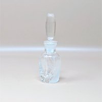 A vintage Lenox glass perfume bottle with the iconic Windswept frosted swirl pattern. The bottle features a tall, smooth clear stopper and is photographed against a neutral dune background.
