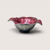 A sand-cast aluminum lily flower bowl with a glossy, jewel-toned raspberry pink enamel interior on a plain background.
