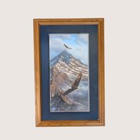 Framed wildlife print showing two bald eagles soaring over a snow covered mountain peak with a dark blue mat.