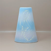 A conical studio pottery vase with a soft blue and pink ombre glaze. The front features an etched sgraffito design of stylized geometric and avian motifs, shown against a neutral background.