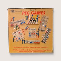 Vintage Chadwick Peg Games box showing seven different wooden puzzle boards with colorful plastic pegs and dice.