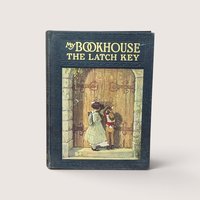 An antique black cloth hardcover book with gold text and a colorful illustration of two children at a large wooden door
